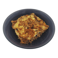 Cargar imagen en el visor de la galería, Veggie enchilada pie made with layered corn tortillas, bean chili, salsa ranchero, veggies and a mix of mozzarella & cheddar cheese. Serves 2. Comes frozen.